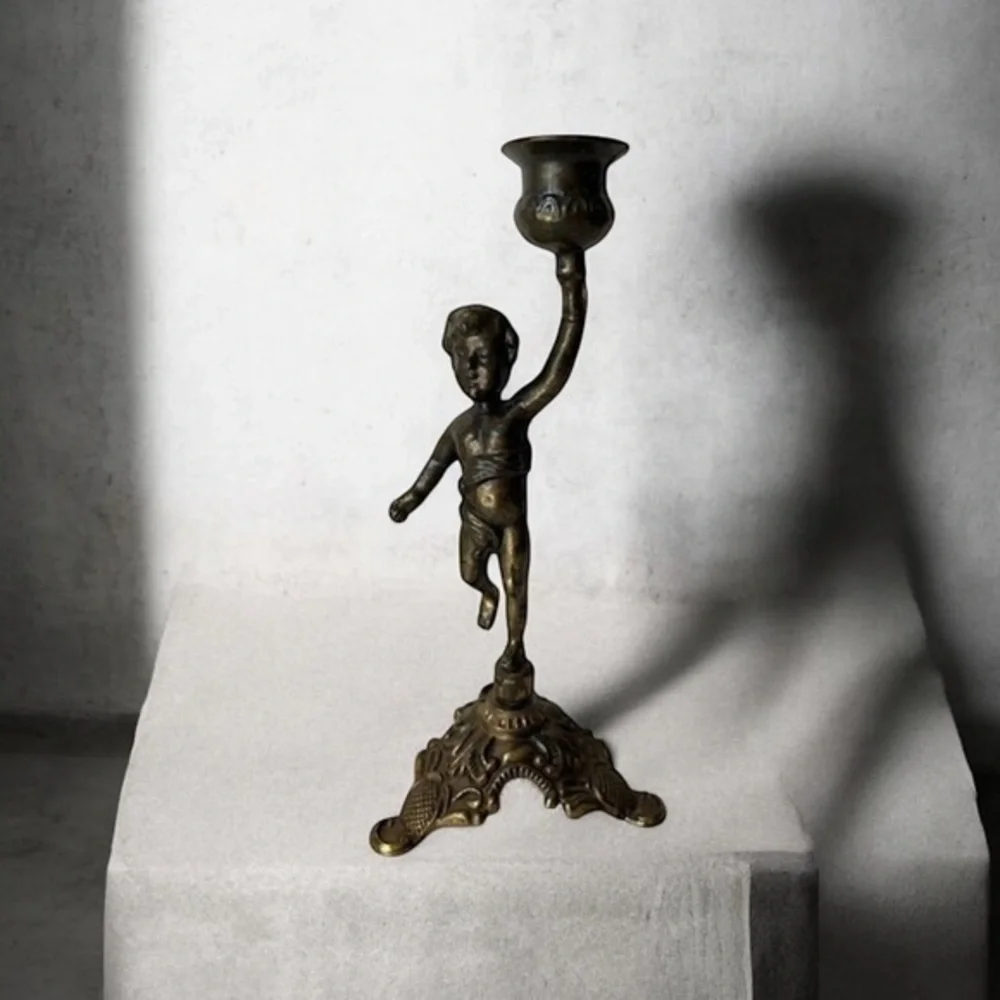 Antique cherub figurine candle holder